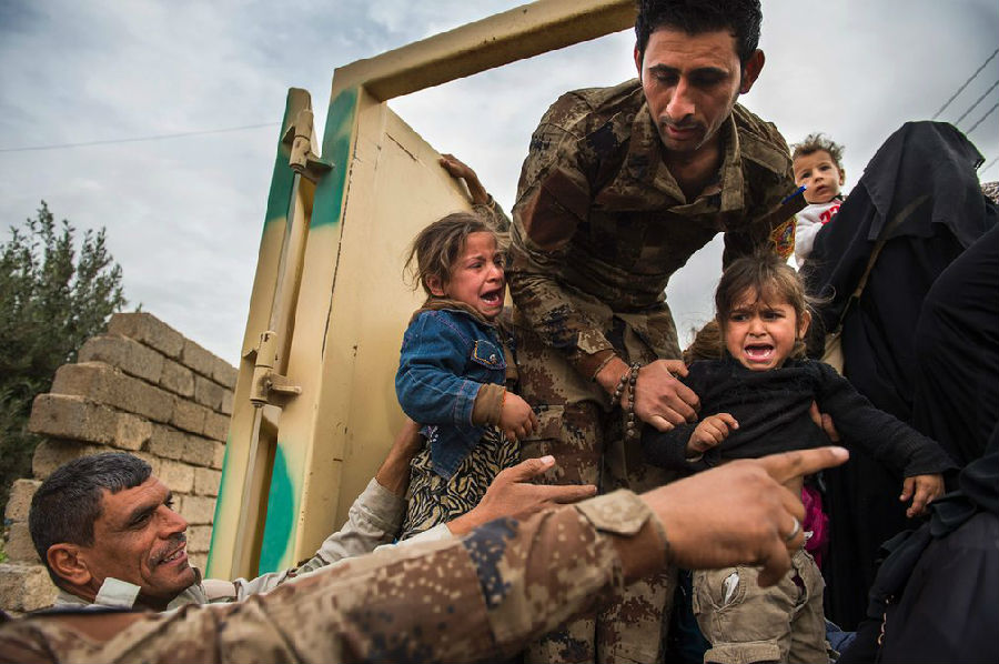 伊拉克士兵帮助女童离开摩苏尔战争地带